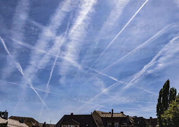 Contrails in the sky. These artificial clouds are created from the exhaust fumes of aeroplanes. But