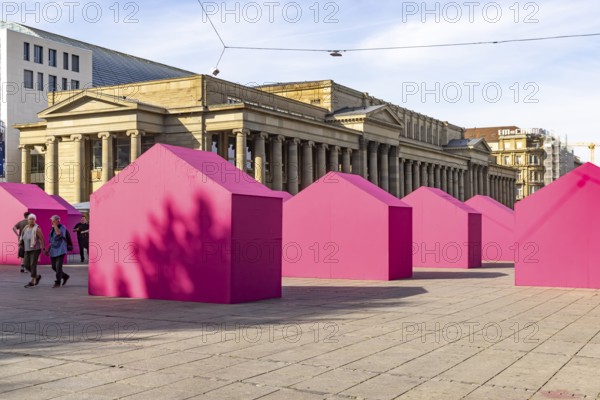 Twelve houses in bright magenta stand on Stuttgart's Schlossplatz in front of the art museum. The