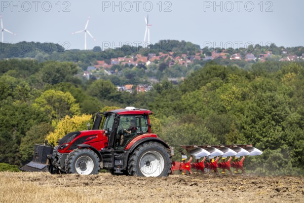 Tractor ploughs up a harvested grain field, south of Billerbeck in Münsterland, North