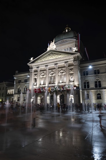 Beautiful Bundeshaus Illuminated Parliament Building or Federal Palace with Water Fountain on