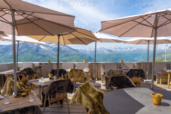 View From a Restaurant Terrace with Parasol and with Mountain Peak in the Swiss Alps and Sky in a