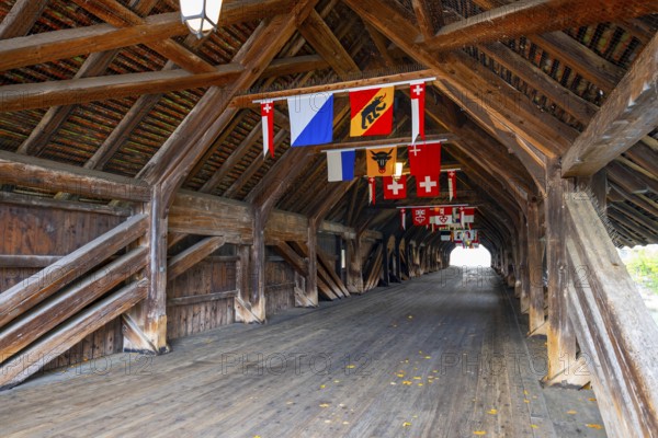 Inside the Old Historical Covered Wood Bridge Holzbrücke with Swiss Canton Flags over River Aare in