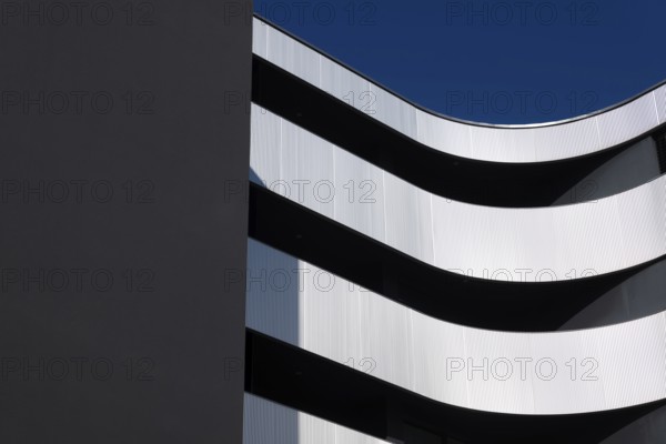 Beautiful Modern Concrete Design Building with Metal Balcony Against Blue Sky in Switzerland