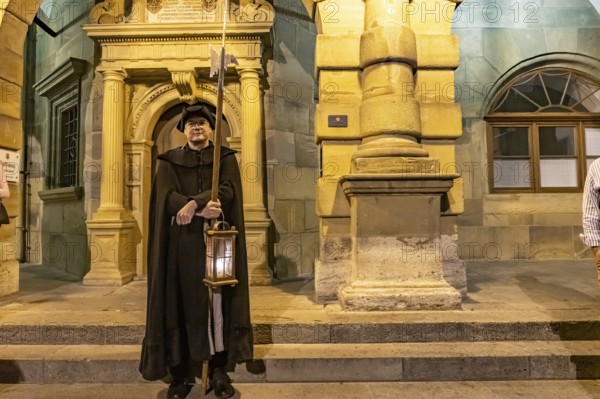 The night watchman in front of the town hall at dusk, Rothenburg ob der Tauber at dusk, Bavaria,