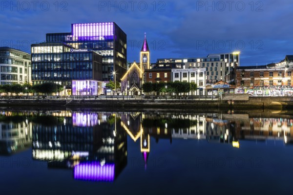Office building and church reflected in the River Liffey, blue hour, Dublin, Ireland