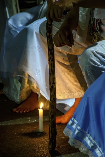 Moment of prayer illuminated by candles in a religious ceremony of Umbanda, Belo Horizonte, Minas