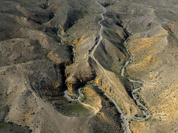 Aerial view of winding hills with a winding road through rocky landscape, aerial view, Angel's
