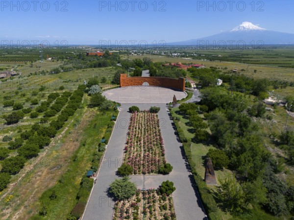 Landscape with symmetrical flower arrangements, a mountain in the background and a calm atmosphere,