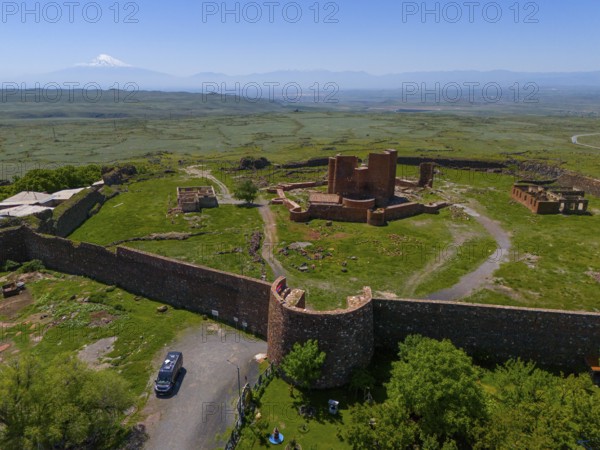 View of a lonely ancient fortress in a vast landscape with a distant mountain, Dashtadem Fortress,