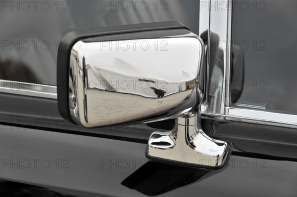 Chrome-plated side mirror of a classic car reflects the surroundings, Retro Classics meets Baroque,