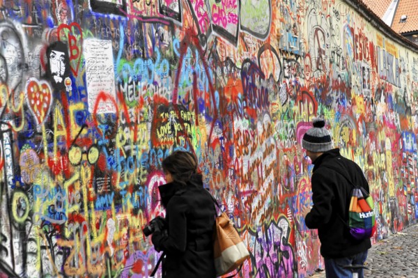 John Lennon Wall, Graffiti, Prague, Czech Republic, Europe, Two people look at a colourful wall