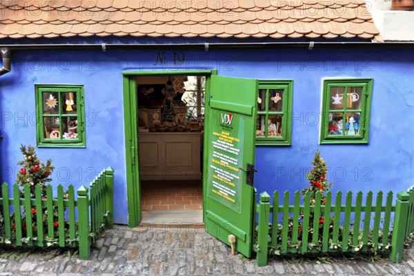 Prague, Czech Republic, Europe, Small blue house with green fence and decorative details in bright