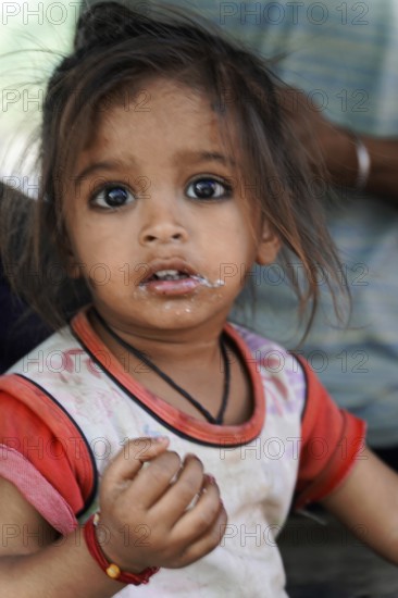 Kota, Rajasthan, North India, Asia, Little girl with natural expression and some dirt on her face,