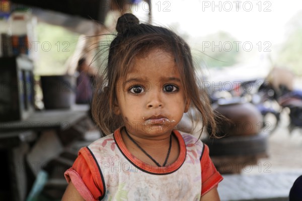 Kota, Rajasthan, North India, Asia, Girl with innocent, questioning look and dirt on her face,