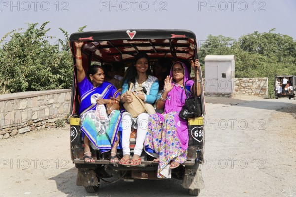 Kota, Rajasthan, North India, Asia, Women in traditional dress sit happily in the back of an