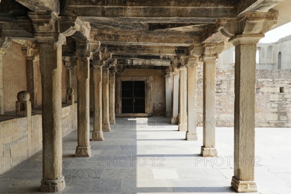 Kota, Rajasthan, North India, Asia, An old stone colonnade full of shadow and light, part of a