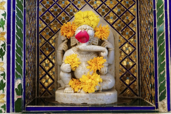 City Palace, Udaipur, Rajasthan, India, Asia, Marble statuette of Ganesha, adorned with flowers, in