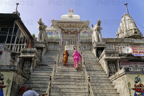Entrance to Jagdish Temple, Udaipur, People climbing the steps to a temple flanked by statues under