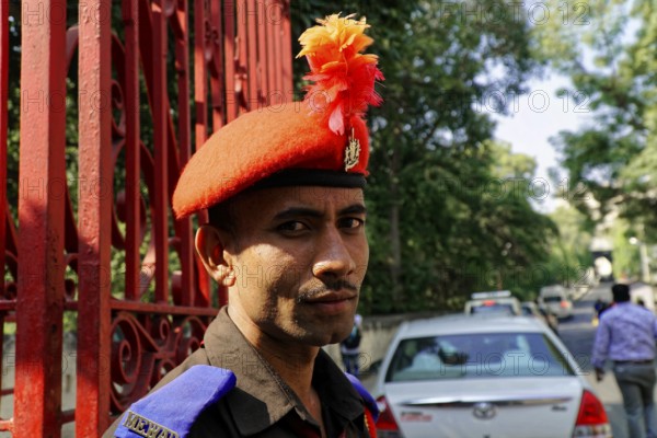 Udaipur, Rajasthan, North India, India, Asia, A guard in uniform with a red beret poses in front of