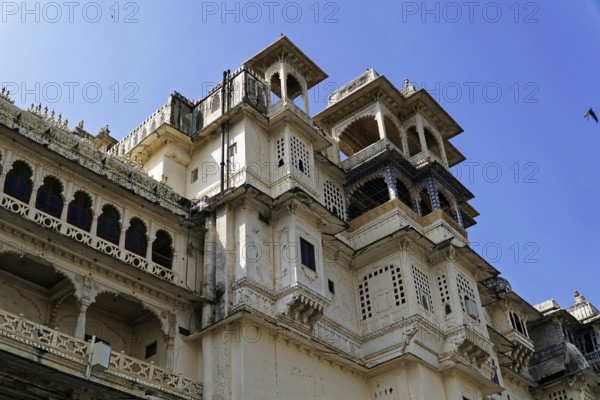 Udaipur, Rajasthan, North India, Asia, White palace with ornate traditional windows and blue sky in