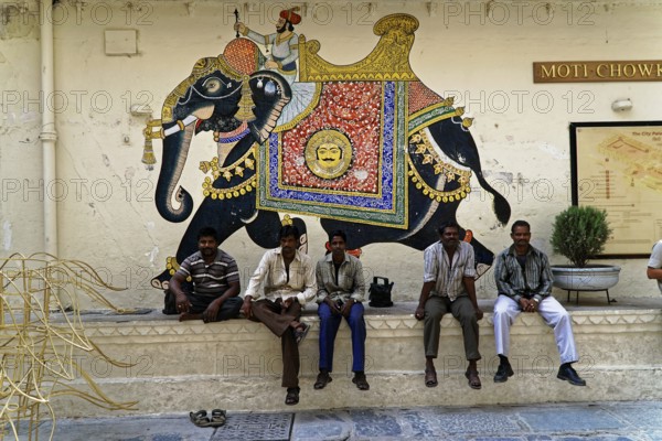 Udaipur, Rajasthan, North India, Asia, Several men sitting in front of an artistically painted