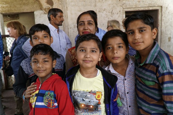 Red Fort, Agra, Uttar Pradesh, India, Group of children smiling friendly in a simple interior with