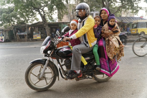 Agra, Jodhpur, Rajasthan, North India, Asia, family with three children on a motorbike on a busy