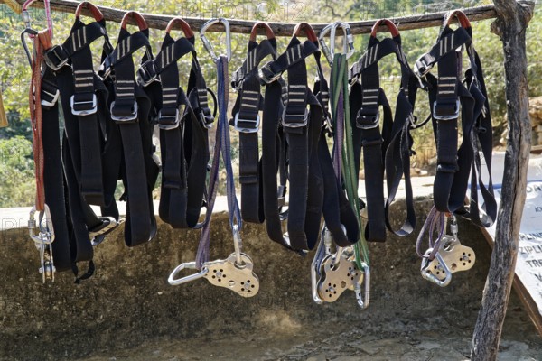 Climbing harnesses and ropes hanging ready for use on a wooden frame, Ranakpur, Jodhpur, Rajasthan,