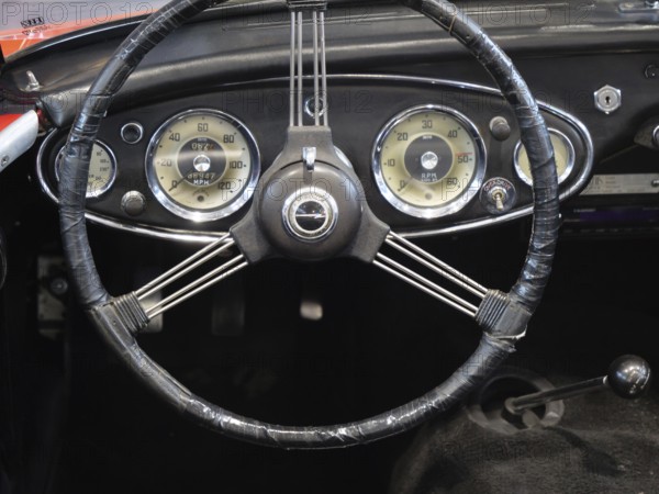 A stylish steering wheel in a classic car, featuring a retro feel and classic instruments, Cologne,