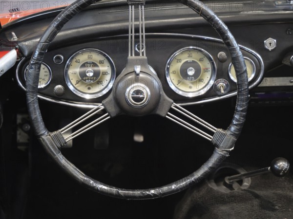 A stylish steering wheel in a classic car, featuring a retro feel and classic instruments, Cologne,