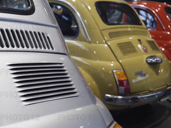 Close-up of colourfully painted vintage cars parked next to each other, creating a nostalgic