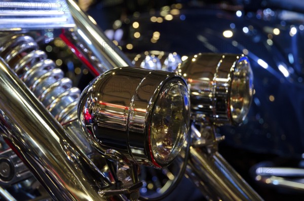 Detailed view of shiny headlights on a motorbike with light-reflecting atmosphere, dortmund,