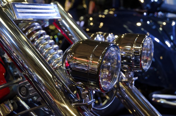 Two shining chrome headlights on a motorbike with blurred background, dortmund, germany