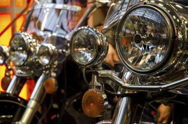 Several motorbikes with striking chrome headlights in a row, dortmund, germany