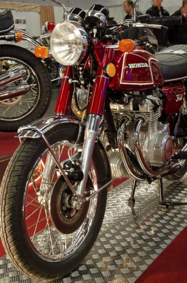 Classic red Honda motorbike with lots of chrome elements in a showroom, dortmund, germany