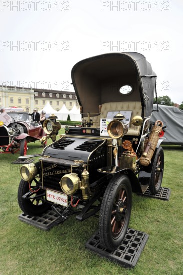 Black and gold classic car with nostalgic retro style, presented at a car exhibition, Retro
