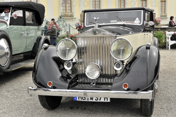 Vintage car in black and cream with dominant front grille and headlights, Retro Classics meets