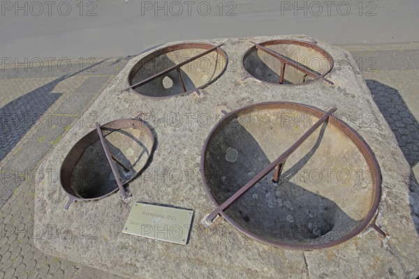 Historic grain stone from 1525, calibration measure for grain, four semicircular holes for