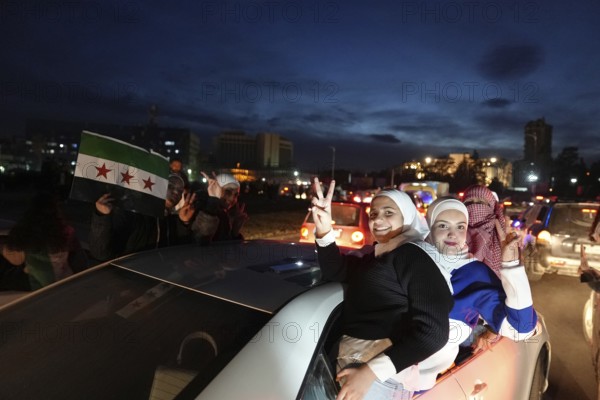 Thousands of Syrians take to public squares and main streets waving the revolutionary flag and