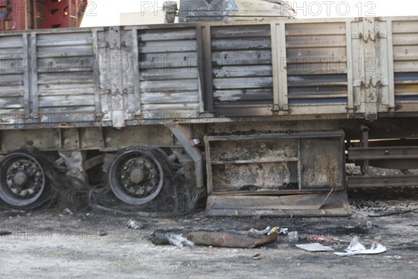 Burned trucks are seen in the opposition-held city of Azaz following shelling by forces loyal to