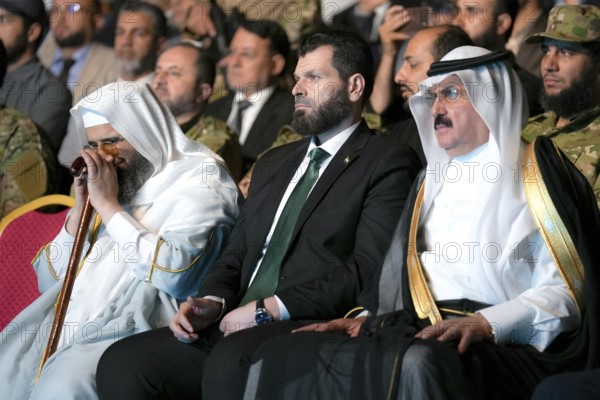 Officials of the new Syrian government take part in a public celebration following the fall of