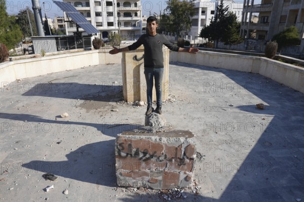 Syrians are seen destroying statues and regime symbols in Damascus after the fall of Bashar