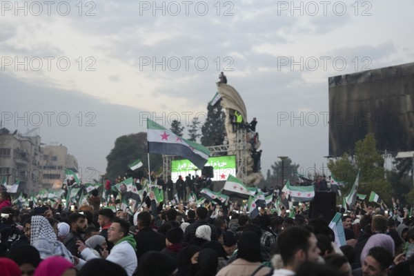 Thousands of Syrians take to public squares and main streets waving the revolutionary flag and