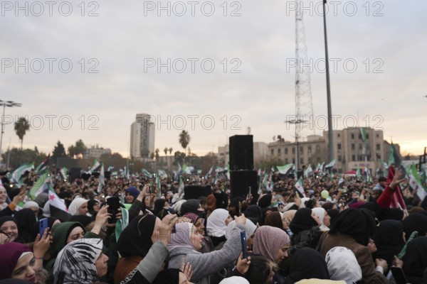 Thousands of Syrians take to public squares and main streets waving the revolutionary flag and