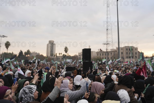 Thousands of Syrians take to public squares and main streets waving the revolutionary flag and