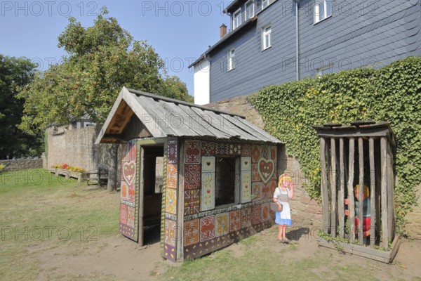 Gingerbread house for the fairy tale Hansel and Gretel, fairy tale figures, hut, wooden posts,