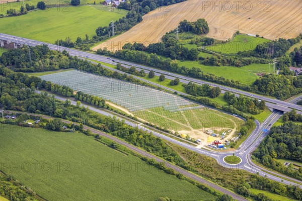 Aerial view, field with construction site for ground-mounted photovoltaic plant solar park at the