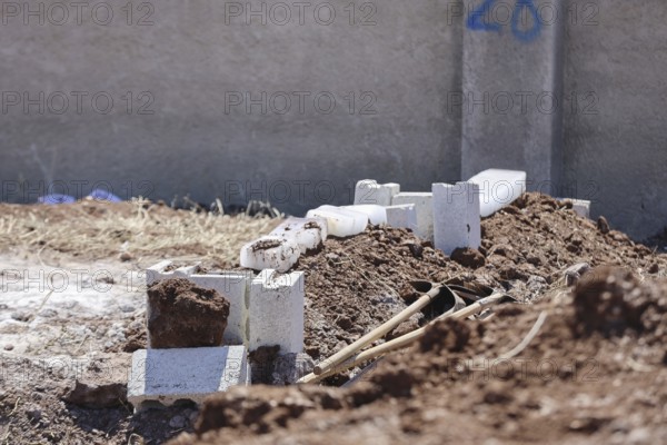 View shows a grave covered with blocks of snow in a cemetery. Azaz, Syria. July 3, 2024, Aleppo,