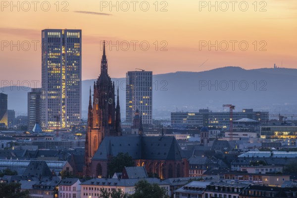 Illuminated Frankfurt Cathedral, Residential Buildings and City at Evening Twilight. Aerial View.