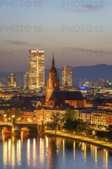 Illuminated Frankfurt Cathedral, Residential Buildings, City and Main River at Night. Aerial View.